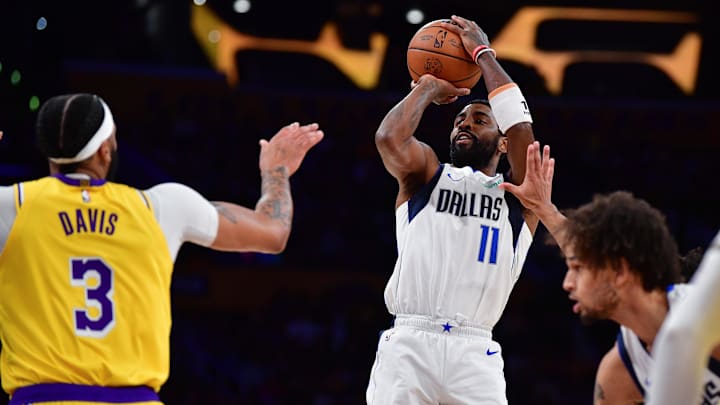 Nov 22, 2023; Los Angeles, California, USA; Dallas Mavericks guard Kyrie Irving (11) shoots against Los Angeles Lakers forward Anthony Davis (3) during the first half at Crypto.com Arena. Mandatory Credit: Gary A. Vasquez-Imagn Images