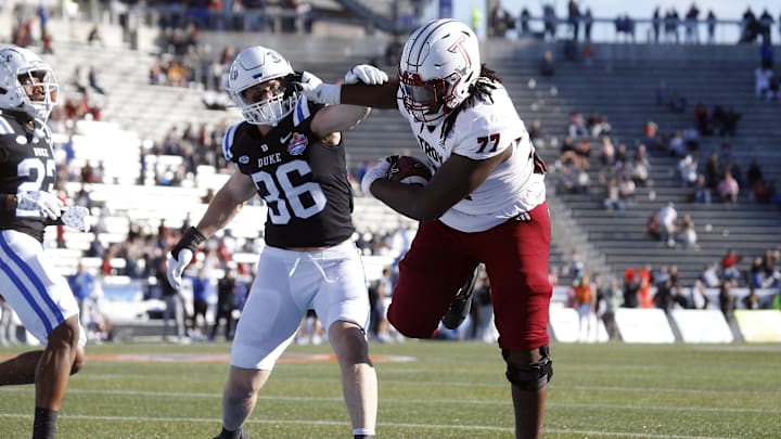 Dec 23, 2023; Birmingham, AL, USA; Troy Trojans offensive linemen Derrick Graham (77) runs after a