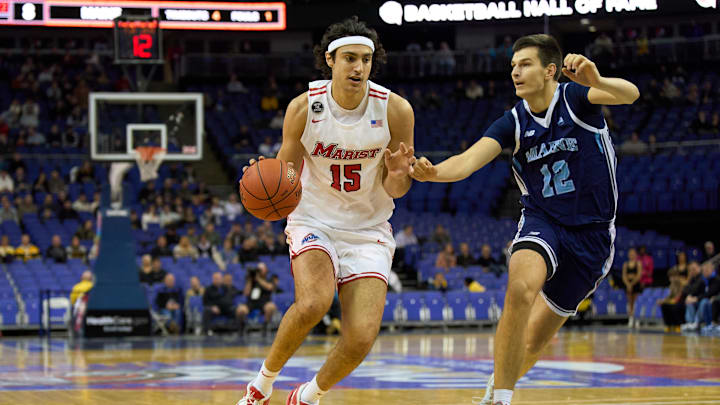 Dec 4, 2022; London, ENG;  Marist Red Foxes center Patrick Gardner (15) controls the ball  under pressure from Maine Black Bears guard Gedi Juozapaitis (22) during the first half at The O2 Arena. Mandatory Credit: Peter van den Berg-Imagn Images