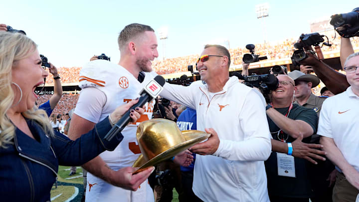 Texas Longhorns quarterback Quinn Ewers (3) celebrates with coach Steve Sarkisian after the Red River Rivalry college football game between the University of Oklahoma Sooners (OU) and the Texas Longhorns at the Cotton Bowl in Dallas, Saturday, Oct. 12, 2024. Texas one 34-3.