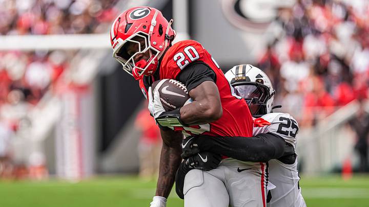 Oct 3, 2026; Athens, Georgia, USA; Georgia Bulldogs running back Dwight Phillips Jr. (20) tries to break a tackle by Vanderbilt Commodores safety Mason Lewis (25) during the first half at Sanford Stadium. Mandatory Credit: Dale Zanine-Imagn Images Oct 3, 2026; Athens, Georgia, USA; Georgia Bulldogs running back Dwight Phillips Jr. (20) tries to break a tackle by Vanderbilt Commodores safety Mason Lewis (25) during the first half at Sanford Stadium. Mandatory Credit: Dale Zanine-Imagn Images