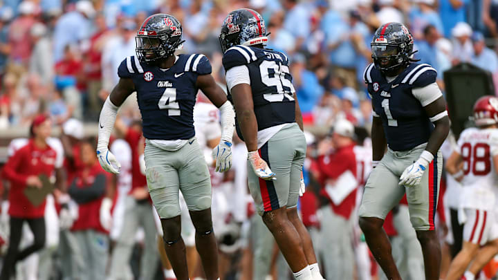 Oct 26, 2024; Oxford, Mississippi, USA; Mississippi Rebels linebacker Suntarine Perkins (4), defensive tackle Akelo Stone (95) and defensive end Princely Umanmielen (1) react after a fourth down stop during the second half against the Oklahoma Sooners at Vaught-Hemingway Stadium. Mandatory Credit: Petre Thomas-Imagn Images