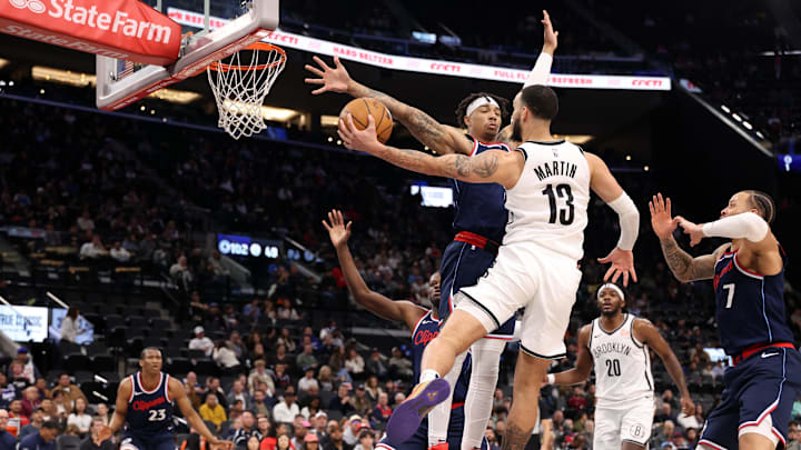 Jan 15, 2025; Inglewood, California, USA;  Brooklyn Nets guard Tyrese Martin (13) passes around LA Clippers guard Jordan Miller (11) during the fourth quarter at Intuit Dome. Mandatory Credit: Kiyoshi Mio-Imagn Images