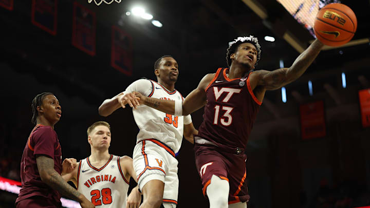 Mar 7, 2026; Charlottesville, Va.; Virginia Tech forward Amani Hansberry (13) reaches for a rebound in front of Virginia center Ugonna Onyenso (33).