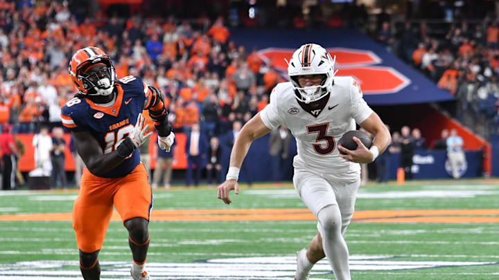 Nov 2, 2024; Syracuse, New York, USA; Virginia Tech Hokies quarterback Collin Schlee (3) runs from Syracuse Orange linebacker David Omopariola (18) in an overtime period at JMA Wireless Dome. Mandatory Credit: Mark Konezny-Imagn Images Nov 2, 2024; Syracuse, New York, USA; Virginia Tech Hokies quarterback Collin Schlee (3) runs from Syracuse Orange linebacker David Omopariola (18) in an overtime period at JMA Wireless Dome. Mandatory Credit: Mark Konezny-Imagn Images