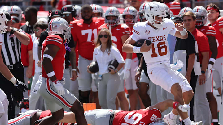 Texas Longhorns quarterback Arch Manning (16) rushes the ball against the Ohio State Buckeyes. Texas Longhorns quarterback Arch Manning (16) rushes the ball against the Ohio State Buckeyes.