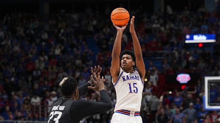 Dec 16, 2025; Lawrence, Kansas, USA; Kansas Jayhawks forward Bryson Tiller (15) shoots against Towson Tigers forward Caleb Embeya (23) during the second half at Allen Fieldhouse. Mandatory Credit: Jay Biggerstaff-Imagn Images Dec 16, 2025; Lawrence, Kansas, USA; Kansas Jayhawks forward Bryson Tiller (15) shoots against Towson Tigers forward Caleb Embeya (23) during the second half at Allen Fieldhouse. Mandatory Credit: Jay Biggerstaff-Imagn Images