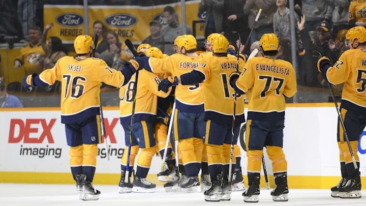 Apr 8, 2025; Nashville, Tennessee, USA;  Nashville Predators center Fedor Svechkiv (40) celebrates his game=winning goal with his teammates  during the over time period at Bridgestone Arena. Mandatory Credit: Steve Roberts-Imagn Images