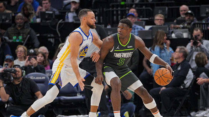 Mar 24, 2024; Minneapolis, Minnesota, USA; Golden State Warriors guard Stephen Curry (30) defends Minnesota Timberwolves guard Anthony Edwards (5) in the third quarter at Target Center. Mandatory Credit: Brad Rempel-Imagn Images