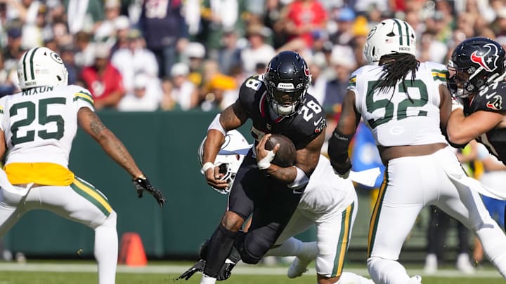 Oct 20, 2024; Green Bay, Wisconsin, USA;  Houston Texans running back Joe Mixon (28) rushes with the football during the second quarter against the Green Bay Packers at Lambeau Field. Mandatory Credit: Jeff Hanisch-Imagn Images