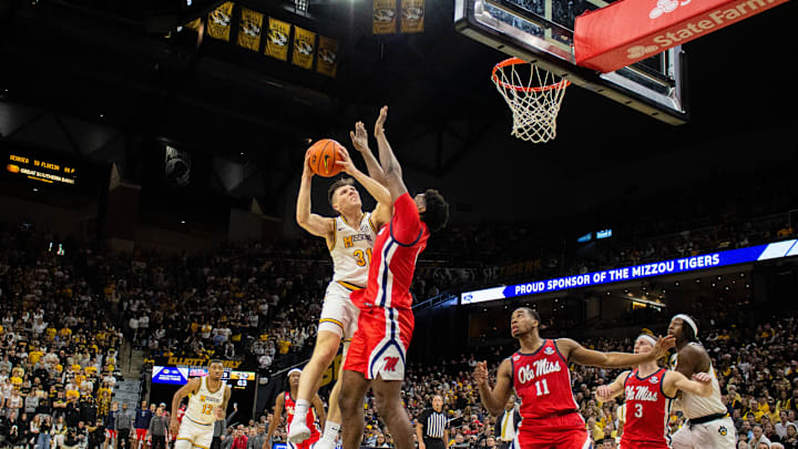 Jan. 25, 2025; Columbia, Missouri, USA; Missouri Tigers guard Caleb Grill (31) drives against Ole Miss forward Malik Dia (0) at Mizzou Arena. 