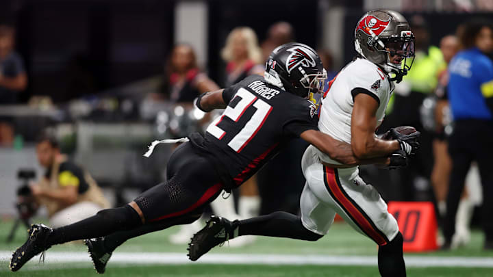Sep 7, 2025; Atlanta, Georgia, USA; Tampa Bay Buccaneers wide receiver Emeka Egbuka (2) runs with the ball for a touchdown against Atlanta Falcons cornerback Mike Hughes (21) during the second quarter at Mercedes-Benz Stadium. Mandatory Credit: Brett Davis-Imagn Images
