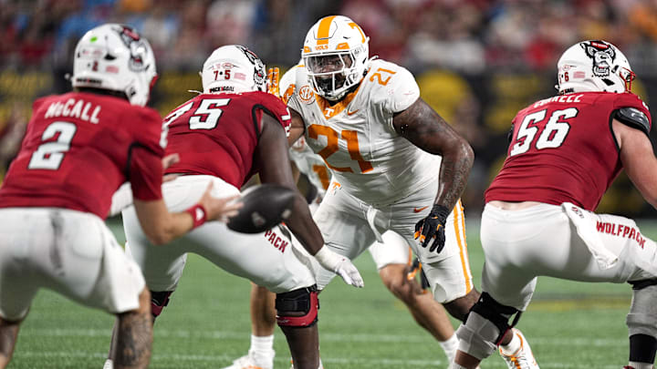 Sep 7, 2024; Charlotte, North Carolina, USA; Tennessee Volunteers defensive lineman Omari Thomas (21) rushes at North Carolina State Wolfpack guard Anthony Carter Jr. (75) during the second half at the Dukes Mayo Classic at Bank of America Stadium. Mandatory Credit: Jim Dedmon-Imagn Images