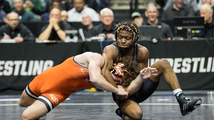 Mar 18, 2023; Tulsa, OK, USA;  Arizona State wrestler Michael McGee (right) wrestles Oklahoma State wrestler Daton Fix in the 133 pound weight class third place match  during the NCAA Wrestling Championships at the BOK Center. Mandatory Credit: Brett Rojo-Imagn Images