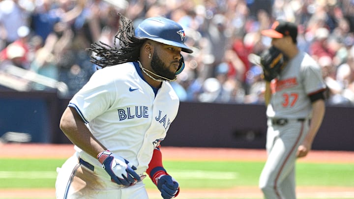 Jun 6, 2024; Toronto, Ontario, CAN;  Toronto Blue Jays first baseman Vladimir Guerrero Jr. (27) runs past Baltimore Orioles pitcher Cade Povich (37) after hitting a three run home run against the Baltimore Orioles in the third inning at Rogers Centre. Mandatory Credit: Dan Hamilton-USA TODAY Sports