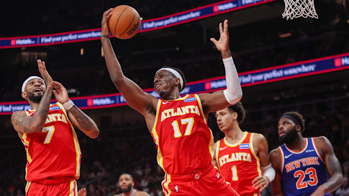 Dec 27, 2025; Atlanta, Georgia, USA; Atlanta Hawks forward Onyeka Okongwu (17) grabs a rebound against the New York Knicks in the second quarter at State Farm Arena. Mandatory Credit: Brett Davis-Imagn Images