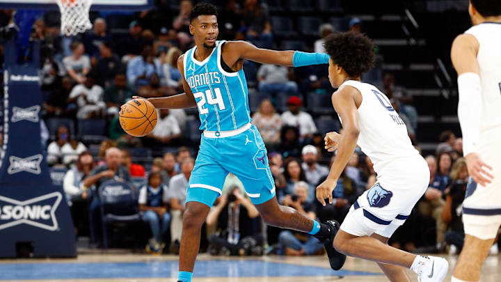 Oct 10, 2024; Memphis, Tennessee, USA; Charlotte Hornets forward Brandon Miller (24) dribbles as Memphis Grizzlies forward Jaylen Wells (0) defends during the first half at FedExForum. Mandatory Credit: Petre Thomas-Imagn Images