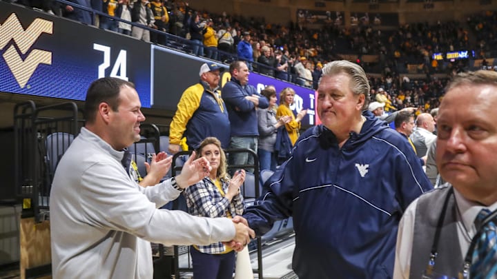 Jan 18, 2023; Morgantown, West Virginia, USA; West Virginia Mountaineers head coach Bob Huggins celebrates with West Virginia University Athletic Director Wren Baker after defeating the TCU Horned Frogs at WVU Coliseum. Mandatory Credit: Ben Queen-Imagn Images