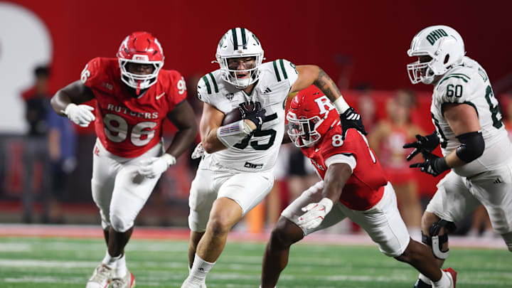 Aug 28, 2025; Piscataway, New Jersey, USA;  Ohio Bobcats tight end Mason Williams (85) gains yards after catch as Rutgers Scarlet Knights linebacker Dariel Djabome (8) tackles during the second half at SHI Stadium. Mandatory Credit: Vincent Carchietta-Imagn Images