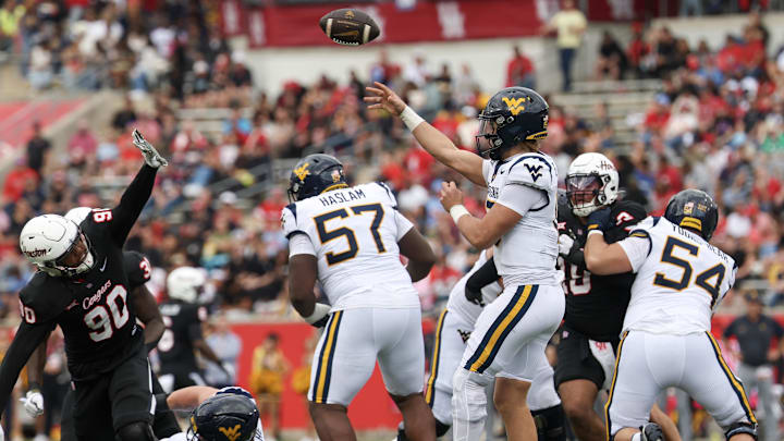 Nov 1, 2025; Houston, Texas, USA; West Virginia Mountaineers quarterback Scotty Fox Jr. (15) passes against Houston Cougars defensive lineman Eddie Walls III (90) in the first half at TDECU Stadium. Mandatory Credit: Thomas Shea-Imagn Images Nov 1, 2025; Houston, Texas, USA; West Virginia Mountaineers quarterback Scotty Fox Jr. (15) passes against Houston Cougars defensive lineman Eddie Walls III (90) in the first half at TDECU Stadium. Mandatory Credit: Thomas Shea-Imagn Images