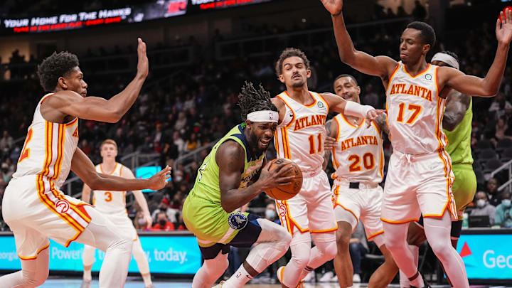 Jan 19, 2022; Atlanta, Georgia, USA; Minnesota Timberwolves guard Patrick Beverley (22) grabs a rebound in front of Atlanta Hawks guard Trae Young (11) during the first half at State Farm Arena. Mandatory Credit: Dale Zanine-Imagn Images