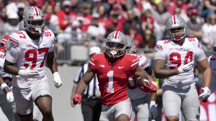 April 13, 2024; Columbus, Ohio, USA; 
Ohio State Buckeyes running back Quinshon Judkins (1) runs the football for the scarlet team while pursued by defensive end Kenyatta Jackson Jr. (97) and Jason Moore (94) of the grey team during the first half of the LifeSports spring football game at Ohio Stadium on Saturday.
