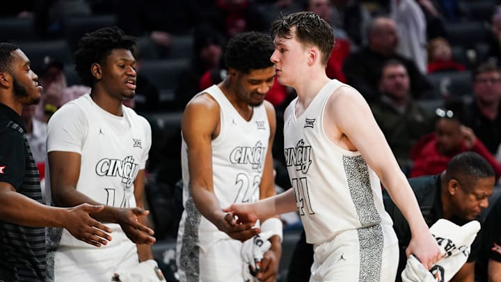 Cincinnati Bearcats guard Simas Lukosius (41) is embraced by his teammates after returning to the bench in the second half of a NCAA men’s basketball game between the Cincinnati Bearcats and Texas Tech Red Raiders, Tuesday, Jan. 21, 2025, at Fifth Third Arena in Cincinnati. Red Raiders won 81-71.