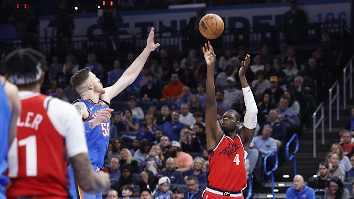 Jan 2, 2025; Oklahoma City, Oklahoma, USA; Los Angeles Clippers center Mo Bamba (4) shoots a three point basket against Oklahoma City Thunder center Isaiah Hartenstein (55) during the second half at Paycom Center. Mandatory Credit: Alonzo Adams-Imagn Images Jan 2, 2025; Oklahoma City, Oklahoma, USA; Los Angeles Clippers center Mo Bamba (4) shoots a three point basket against Oklahoma City Thunder center Isaiah Hartenstein (55) during the second half at Paycom Center. Mandatory Credit: Alonzo Adams-Imagn Images