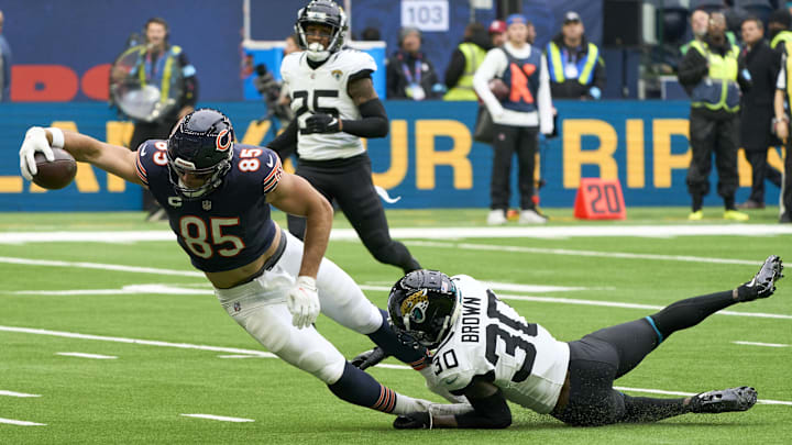 Oct 13, 2024; London, United Kingdom; Jacksonville Jaguars cornerback Montaric Brown (30) tackles Chicago Bears tight end Cole Kmet (85) as he scores a touchdown during an NFL International Series game at Tottenham Hotspur Stadium. Mandatory Credit: Peter van den Berg-Imagn Images