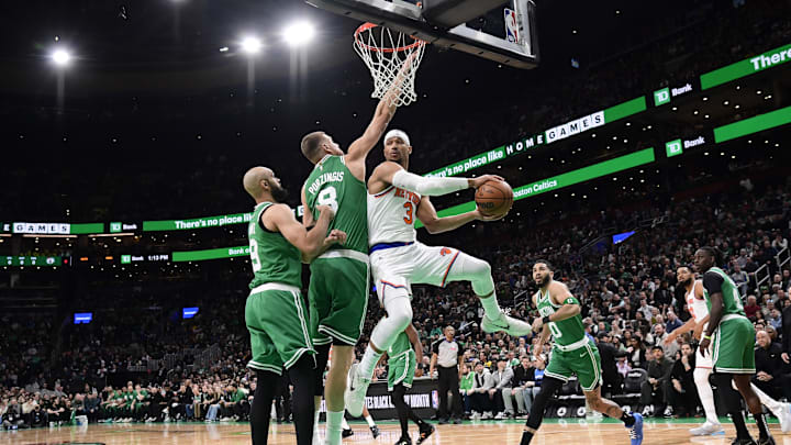 Feb 23, 2025; Boston, Massachusetts, USA;  New York Knicks guard Josh Hart (3) looks to pass the ball past Boston Celtics center Kristaps Porzingis (8) and h9#@ during the first half at TD Garden. Mandatory Credit: Bob DeChiara-Imagn Images