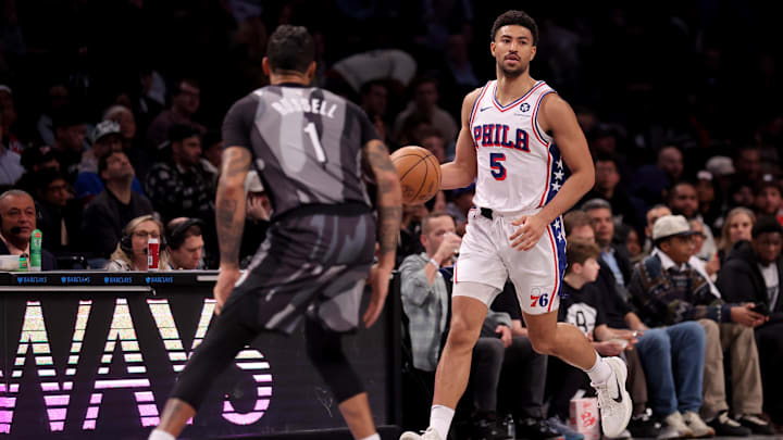 Feb 12, 2025; Brooklyn, New York, USA; Philadelphia 76ers guard Quentin Grimes (5) brings the ball up court against Brooklyn Nets guard D'Angelo Russell (1) during the third quarter at Barclays Center. Mandatory Credit: Brad Penner-Imagn Images
