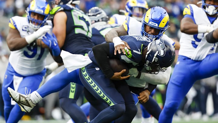 Nov 3, 2024; Seattle, Washington, USA; Los Angeles Rams linebacker Jared Verse (8) sacks Seattle Seahawks quarterback Geno Smith (7) during the second quarter at Lumen Field. Mandatory Credit: Joe Nicholson-Imagn Images