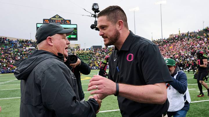 Oct 22, 2022; Eugene, Oregon, USA; UCLA Bruins head coach Chip Kelly, left, congratulates Oregon Ducks head coach Dan Lanning after a game at Autzen Stadium. The Ducks won the game 45-30. Mandatory Credit: Troy Wayrynen-USA TODAY Sports