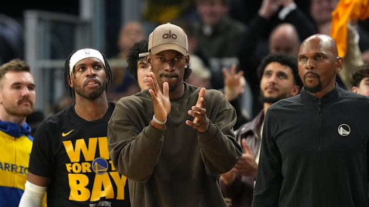 Apr 26, 2025; San Francisco, California, USA; Golden State Warriors forward Jimmy Butler III (center) applauds from the bench against the Houston Rockets during the third quarter of game three of first round for the 2024 NBA Playoffs at Chase Center. Mandatory Credit: Darren Yamashita-Imagn Images