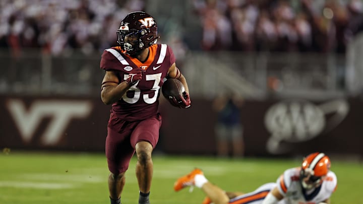 Oct 26, 2023; Blacksburg, Virginia, USA; Virginia Tech Hokies running back Bhayshul Tuten (33) runs the ball against Syracuse Orange defensive back Justin Barron (8) during the fourth quarter at Lane Stadium. Mandatory Credit: Peter Casey-USA TODAY Sports
