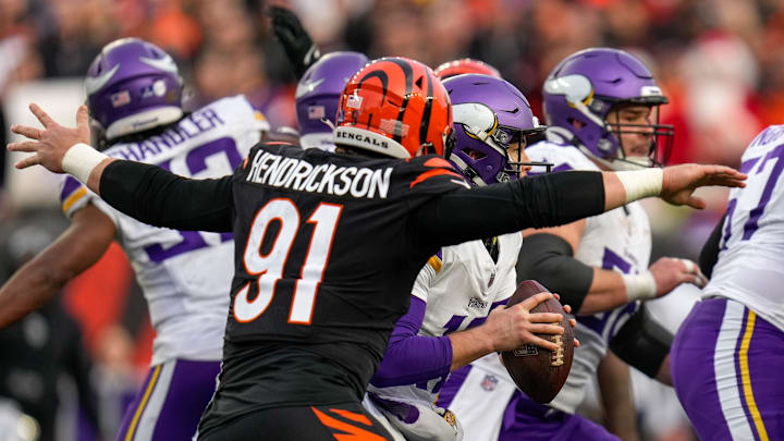 Cincinnati Bengals defensive end Trey Hendrickson (91) wraps up Minnesota Vikings quarterback Nick Mullens (12) for a loss in the fourth quarter of the NFL Week 15 game between the Cincinnati Bengals and the Minnesota Vikings at PayCor Stadium in downtown Cincinnati on Saturday, Dec. 16, 2023. The Bengals won on an overtime field goal. Cincinnati Bengals defensive end Trey Hendrickson (91) wraps up Minnesota Vikings quarterback Nick Mullens (12) for a loss in the fourth quarter of the NFL Week 15 game between the Cincinnati Bengals and the Minnesota Vikings at PayCor Stadium in downtown Cincinnati on Saturday, Dec. 16, 2023. The Bengals won on an overtime field goal.