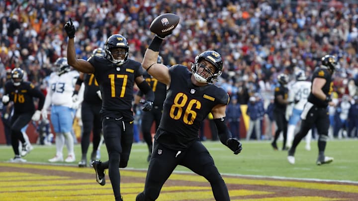 Dec 1, 2024; Landover, Maryland, USA; Washington Commanders tight end Zach Ertz (86) spikes the ball in the end zone after catching a touchdown pass as Commanders wide receiver Terry McLaurin (17) celebrates against the Tennessee Titans during the fourth quarter at Northwest Stadium. Mandatory Credit: Geoff Burke-Imagn Images
