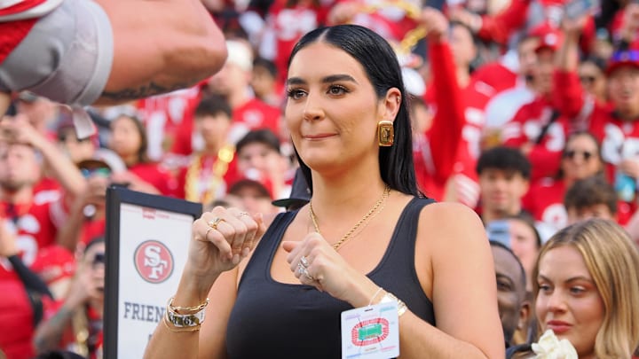 San Francisco 49ers tight end George Kittle (85) prepares to hug his wife Claire Kittle before the NFC Championship football game against the Detroit Lions at Levi's Stadium.