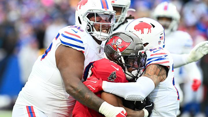 Buffalo Bills defensive tackle Deone Walker (96) and safety Jordan Poyer (21) tackle Tampa Bay Buccaneers running back Sean Tucker (44) during the first quarter of the game at Highmark Stadium. Buffalo Bills defensive tackle Deone Walker (96) and safety Jordan Poyer (21) tackle Tampa Bay Buccaneers running back Sean Tucker (44) during the first quarter of the game at Highmark Stadium.
