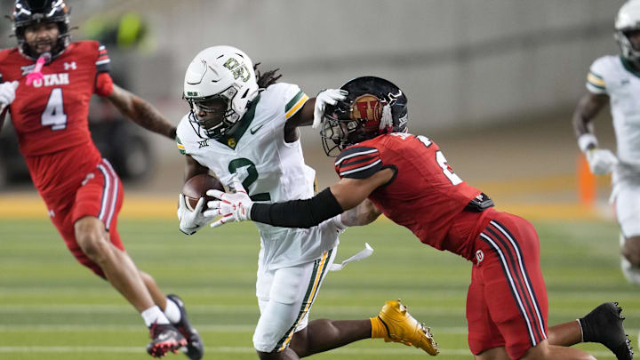 Nov 15, 2025; Waco, Texas, USA; Baylor Bears wide receiver Kole Wilson (2) is tackled after the catch by Utah Utes cornerback Smith Snowden (2) during the first half at McLane Stadium. Mandatory Credit: Chris Jones-Imagn Images