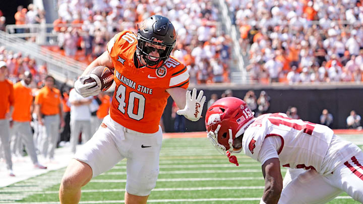 Oklahoma State's Josh Ford (40) looks to get past Arkansas' Jaheim Singletary (15) in the second half of the college football game between the Oklahoma State Cowboys and the Arkansas Razorbacks at Boone Pickens Stadium in Stillwater, Okla.,, Saturday, Sept., 7, 2024. Oklahoma State's Josh Ford (40) looks to get past Arkansas' Jaheim Singletary (15) in the second half of the college football game between the Oklahoma State Cowboys and the Arkansas Razorbacks at Boone Pickens Stadium in Stillwater, Okla.,, Saturday, Sept., 7, 2024.