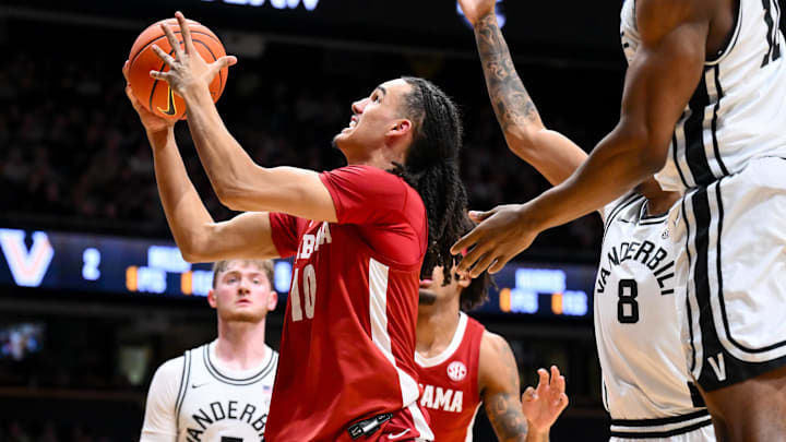 Jan 7, 2026; Nashville, Tennessee, USA;  Alabama Crimson Tide forward Keitenn Bristow (10) lays the ball in under the arm of Vanderbilt Commodores forward Ak Okereke (10) during the first half at Memorial Gymnasium. Mandatory Credit: Steve Roberts-Imagn Images
