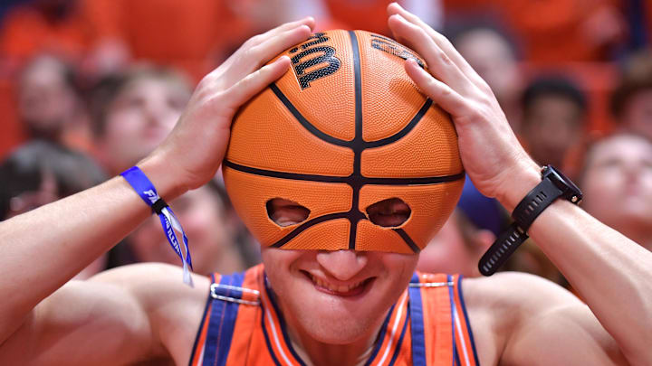 Feb 25, 2025; Champaign, Illinois, USA;  an Illinois Fighting Illini fan dons a basketball during the first half against the Iowa Hawkeyes at State Farm Center. Mandatory Credit: Ron Johnson-Imagn Images