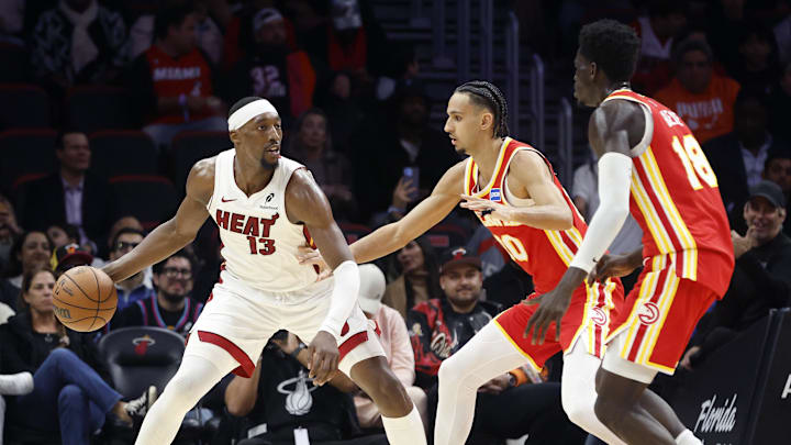 Feb 3, 2026; Miami, Florida, USA;  Atlanta Hawks forward Zaccharie Risacher (10) and forward Mouhamed Gueye (18) defend Miami Heat center Bam Adebayo (13) during the second half at Kaseya Center. Mandatory Credit: Rhona Wise-Imagn Images