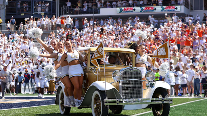 Sep 13, 2025; Atlanta, Georgia, USA; Georgia Tech Yellow Jackets cheerleaders ride the Ramblin' Wreck car on the field before a game against the Clemson Tigers at Bobby Dodd Stadium at Hyundai Field. Mandatory Credit: Brett Davis-Imagn Images Sep 13, 2025; Atlanta, Georgia, USA; Georgia Tech Yellow Jackets cheerleaders ride the Ramblin' Wreck car on the field before a game against the Clemson Tigers at Bobby Dodd Stadium at Hyundai Field. Mandatory Credit: Brett Davis-Imagn Images