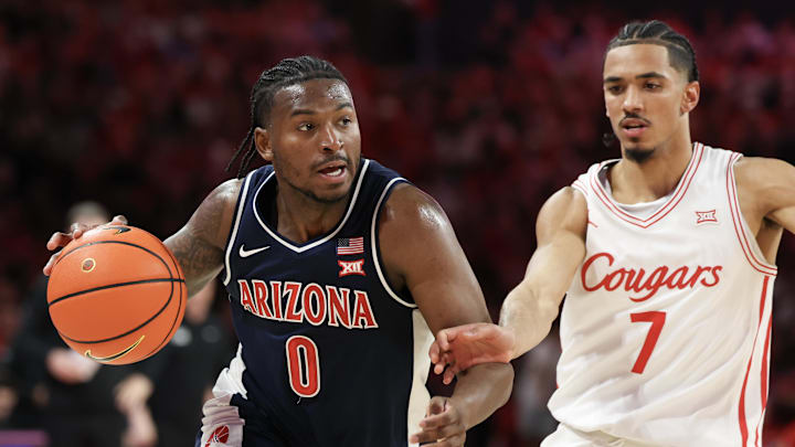 Feb 21, 2026; Houston, Texas, USA;  Arizona Wildcats guard Jaden Bradley (0) dribbles against Houston Cougars guard Milos Uzan (7) in the first half at Fertitta Center. Mandatory Credit: Thomas Shea-Imagn Images