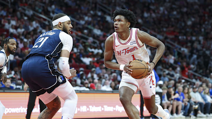 Mar 31, 2024; Houston, Texas, USA; Houston Rockets forward Amen Thompson (1) drives with the ball as Dallas Mavericks center Daniel Gafford (21) defends during the first half at Toyota Center. Mandatory Credit: Troy Taormina-USA TODAY Sports