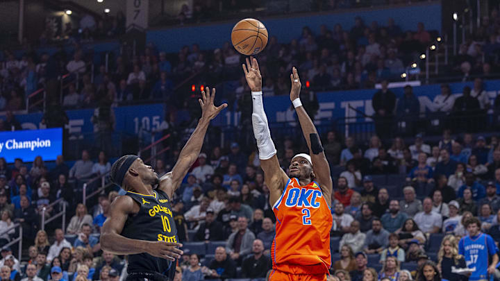 Nov 11, 2025; Oklahoma City, Oklahoma, USA; Oklahoma City Thunder guard Shai Gilgeous-Alexander (2) shoots as Golden State Warriors forward Jimmy Butler III (10) defends during the first quarter at Paycom Center. Mandatory Credit: Alonzo Adams-Imagn Images
