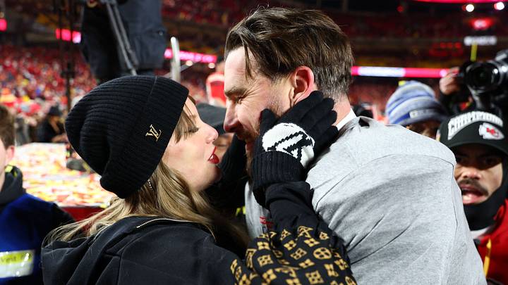 Jan 26, 2025; Kansas City, MO, USA; Recording artist Taylor Swift  and Kansas City Chiefs tight end Travis Kelce (87) react after the AFC Championship game against the Buffalo Bills at GEHA Field at Arrowhead Stadium. Mandatory Credit: Mark J. Rebilas-Imagn Images