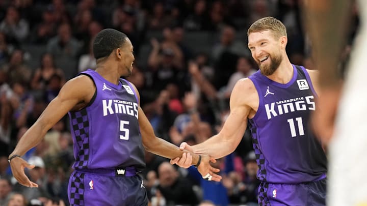 Dec 8, 2024; Sacramento, California, USA; Sacramento Kings forward Domantas Sabonis (11) is congratulated by guard De'Aaron Fox (5) after making a three point basket against the Utah Jazz during the second quarter at Golden 1 Center. Mandatory Credit: Darren Yamashita-Imagn Images